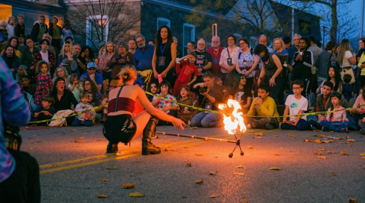 A street performer juggles a flaming baton at the Beacon Bonfire, photo by Daniel Rowan